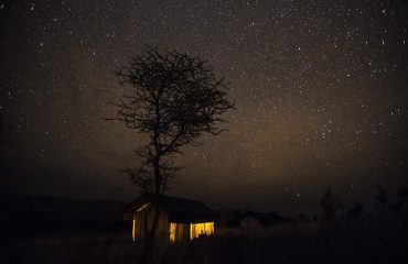 Kiota camp illuminated by the spectacular African night sky